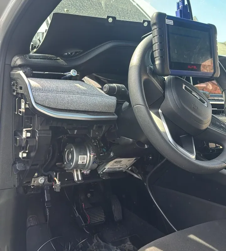 Jeep dashboard opened with a key programmer mounted on the steering wheel