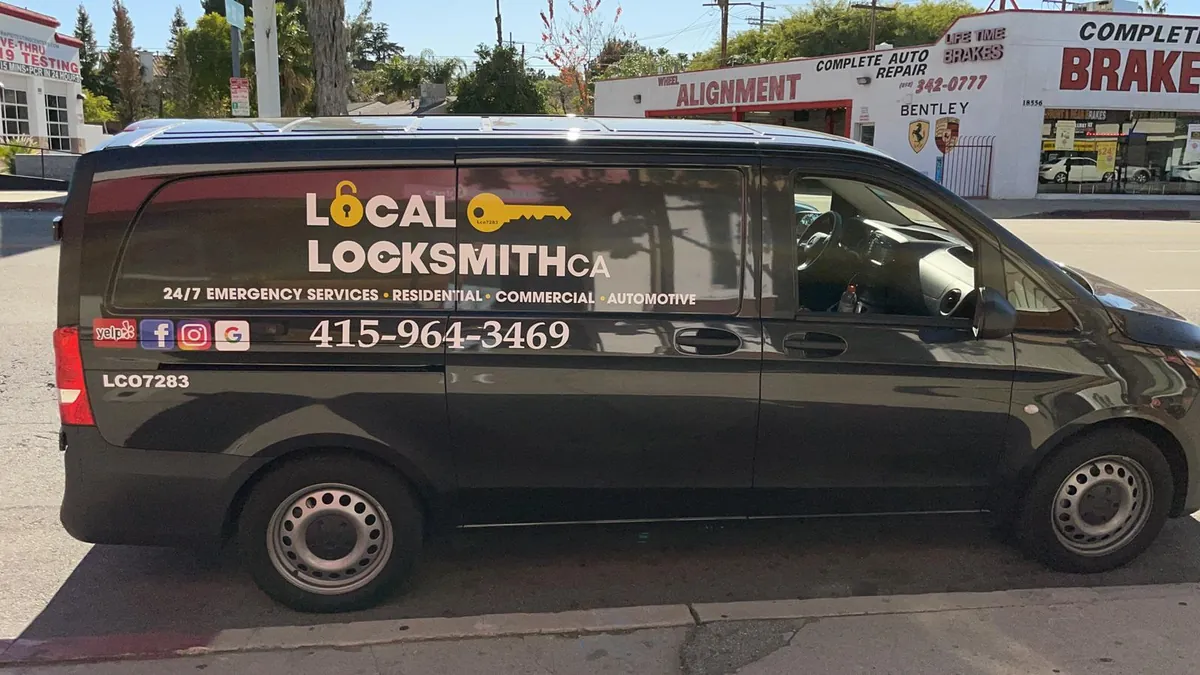 Local Locksmith CA van with the phone number on the side, parked on a street